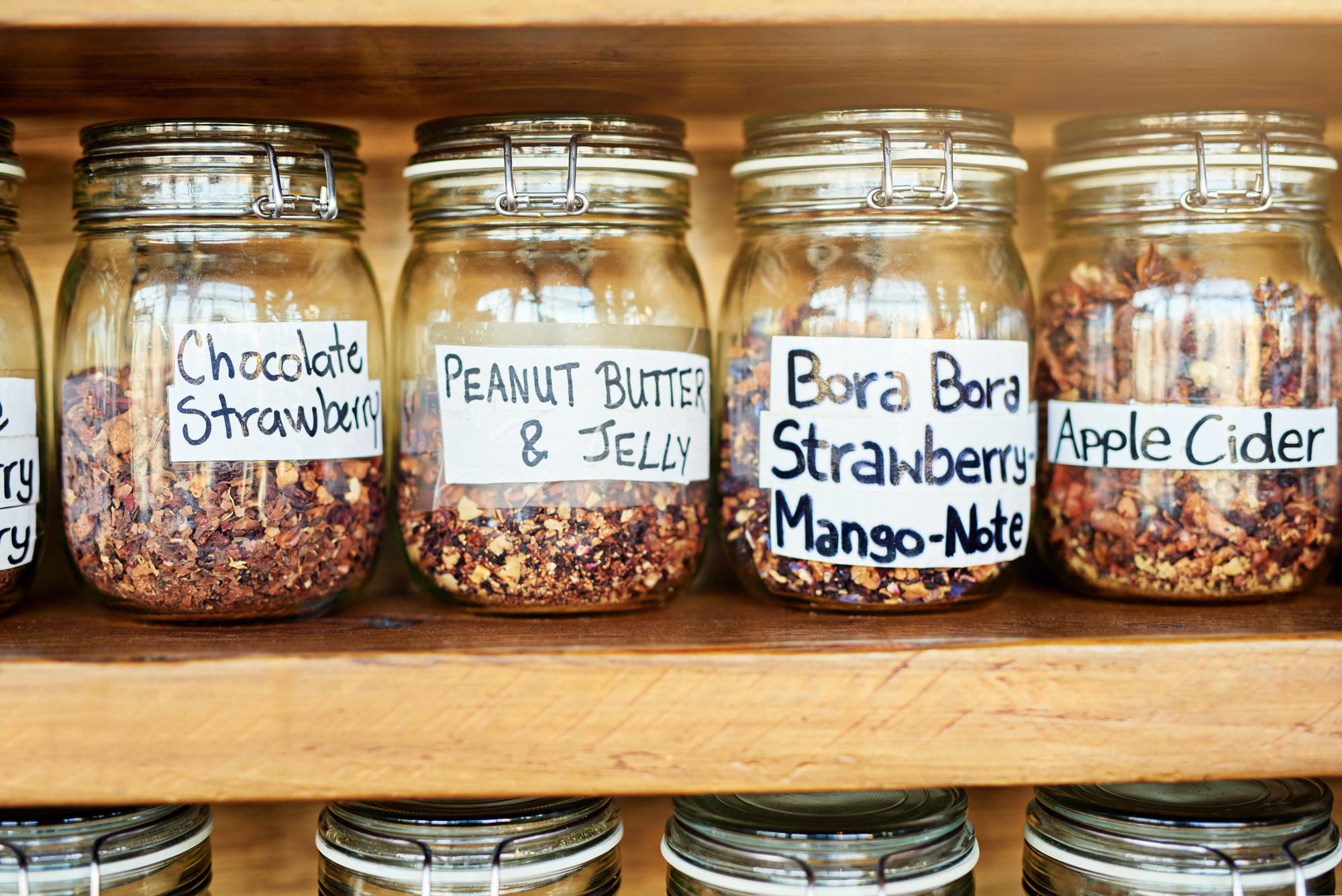 row of preserved jars with labels on shelf