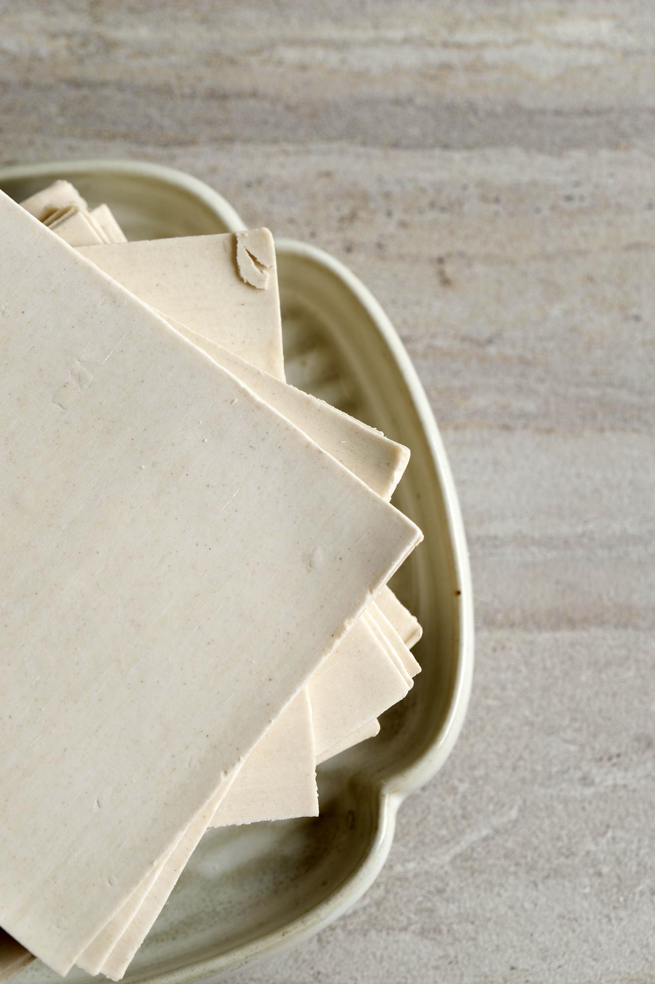 three stacked recipe booklets on a linen